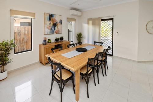a dining room with a wooden table and chairs at Bayview Beauty - Four Bedroom in Stuart Park