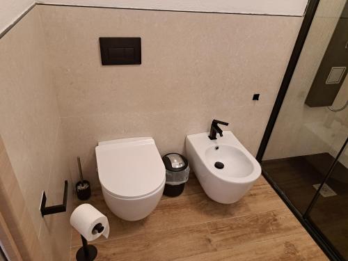 a bathroom with a toilet and a sink at Struttura Monte Olimpo in Porto Torres