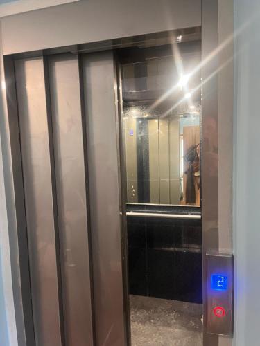 a elevator in a building with a mirror at Tumbledown Hotel in Shrewsbury