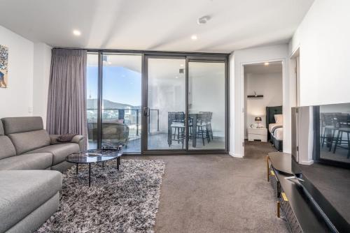 a living room with a couch and a table at Park Avenue Apt in the Heart of the City - Hosted by CanStay in Canberra