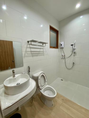 a white bathroom with a sink and a toilet at Esther Villa Khaoyai in Ban Bung Toei