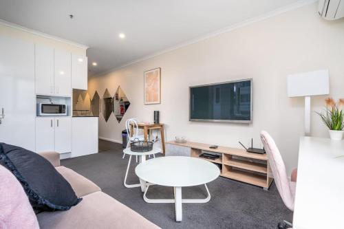 a living room with a couch and a table at 2BR Apt in the heart of the Gungahlin Town Centre - Hosted by CanStay in Harrison