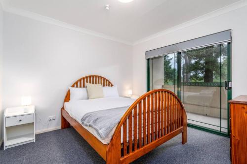 a bedroom with a bed and a large window at 2BR Apartment Close to Glebe Park and Canberra City - Hosted by CanStay in Canberra