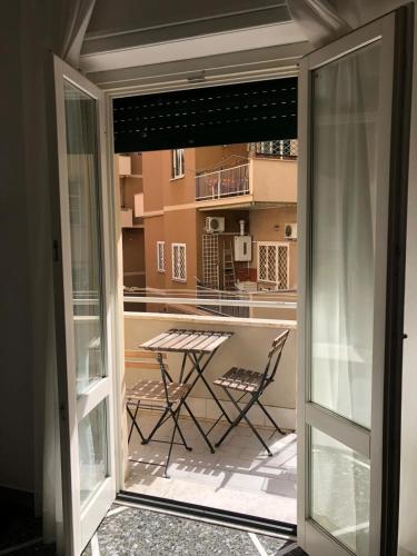 a glass door leading to a patio with a table at L'Angolo Di San Pietro in Rome
