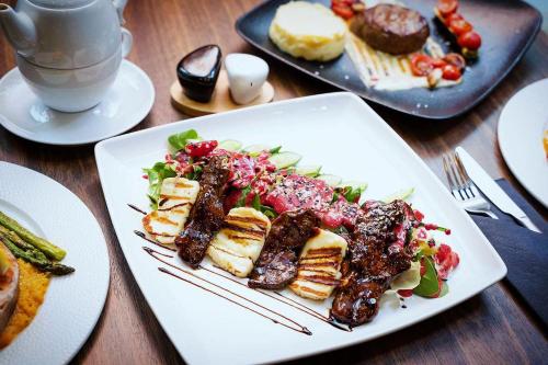 a white plate of food on a table with food at Centrum3a Łódź Próchnika 21 in Łódź