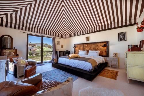 a bedroom with a bed and a large window at Ali Baba Infinity in Essaouira