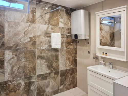 a bathroom with a sink and a shower at Step to Kotor bay Perast in Perast
