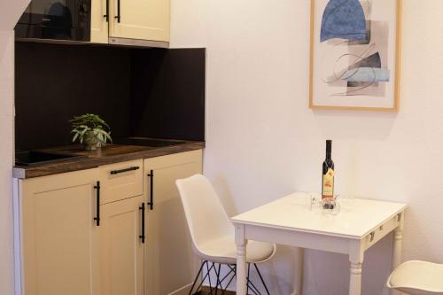 a small white table with a bottle of wine on it at Step to Kotor bay Perast in Perast