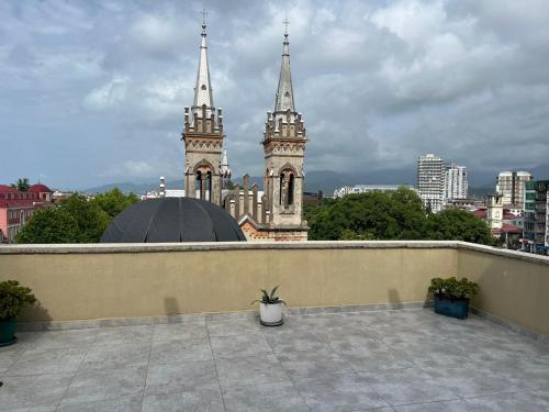 a white vase sitting on a ledge with two towers at Terrace View in Batumi