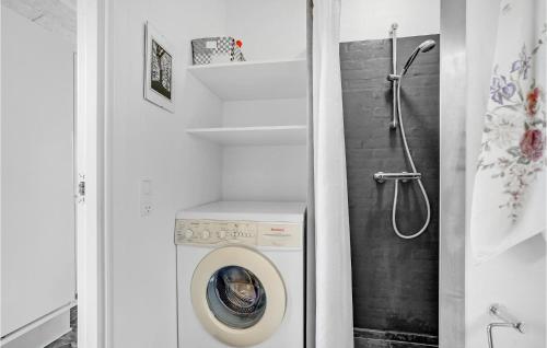 a bathroom with a washing machine and a shower at Three-Bedroom Holiday Home In Skals in Skals