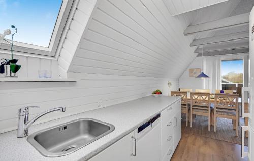 a kitchen with a sink and a table at 3 Bedroom Amazing Home In Kalundborg in Kalundborg