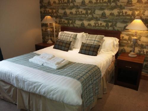 a bedroom with a bed with two towels on it at The Huntsman Inn in Holmfirth
