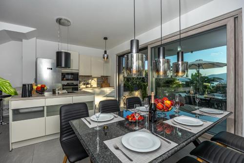 a kitchen and dining room with a table and chairs at Luxury White Sails Villas with a Multi Sport Court #2026# and Sea View in Pinezici
