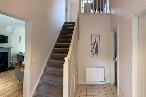 a staircase in a living room with a stair case at House Bunratty Castle gardens in Bunratty