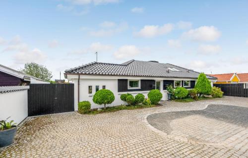 a white house with a black fence and a driveway at Awesome Home In Slagelse With Wifi in Slagelse