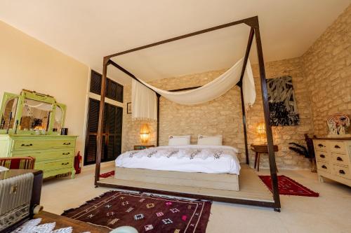 a bedroom with a bed with a canopy at Ali Baba Infinity in Essaouira