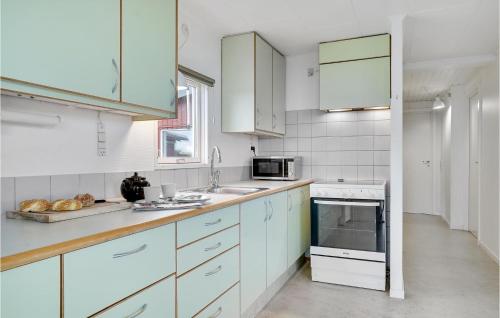a kitchen with white cabinets and a counter top at Holiday Home Huginsvej in Slagelse