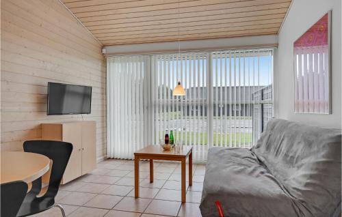 a living room with a couch and a table at 2 Bedroom Stunning Home In Pandrup in Pandrup