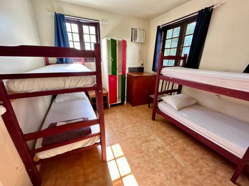 a room with four bunk beds in a dorm at Hostel e Pousada Barra da Tijuca in Rio de Janeiro