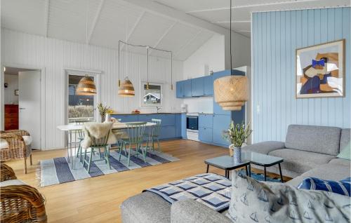 a living room with a couch and a table at Holiday Home Bygmarken Sjølund Denm in Sjølund