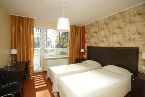 Säng eller sängar i ett rum på Pühajärve Spa & Holiday Resort