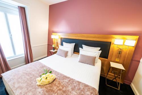 a hotel room with a bed with a bowl of fruit on it at Hôtel Le Cercle Tour Eiffel in Paris