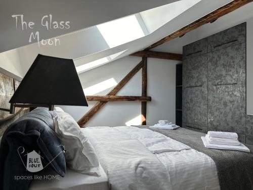 a bedroom with a bed with a lamp on it at Пространства за гости Синият час - апартамент The Glass Moon in Ruse