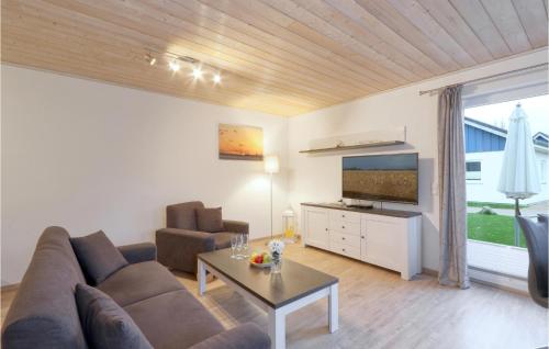 a living room with a couch and a tv at Ferienhaus 12 Altefähr in Altefähr