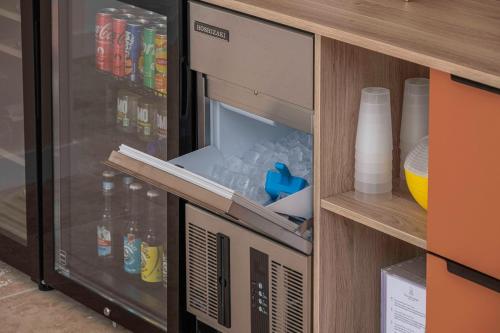 an open refrigerator with drinks in it at Clos Marcamps - Teritoria in Prignac-et-Marcamps