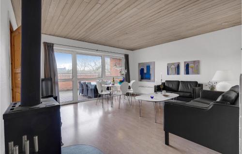 a living room with a couch and a fireplace at Holiday Home Romo 22 With Hot Tub in Rømø Kirkeby