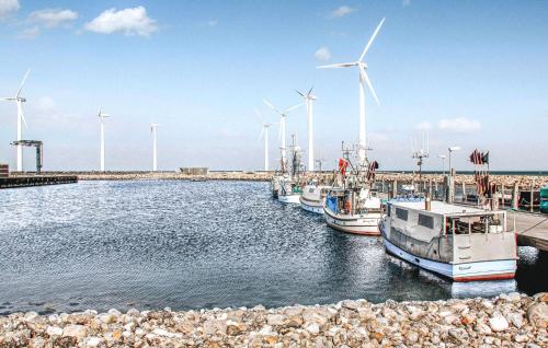 a group of boats docked in a harbor with windmills at 2 Bedroom Gorgeous Home In Glesborg in Glesborg