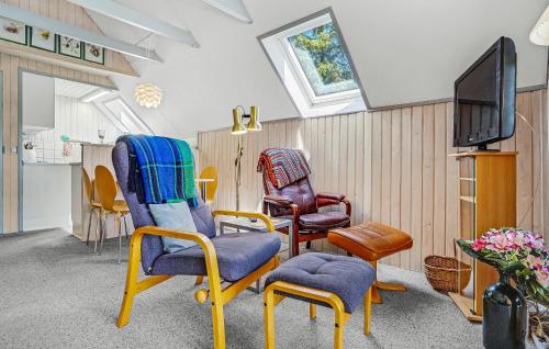 a living room with chairs and a tv at 2 Bedroom Gorgeous Home In Glesborg in Glesborg