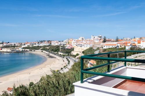 a view of the beach from the balcony of a house at Sines beach front Villa in Sines