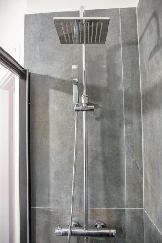 a shower with a shower head in a bathroom at Sea Point in Celle Ligure