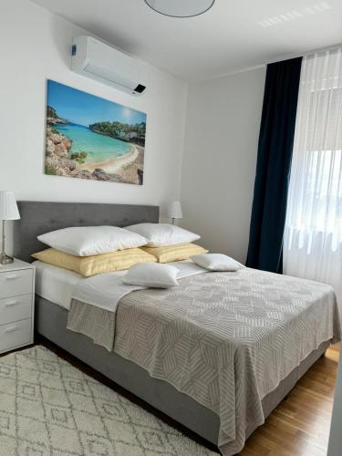 a bedroom with a bed and a painting on the wall at Palm Blues in Vodice