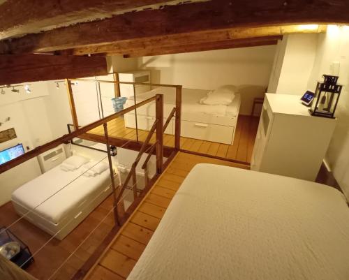 a small room with two beds and a refrigerator at La Loge Du Vieux Lyon in Lyon