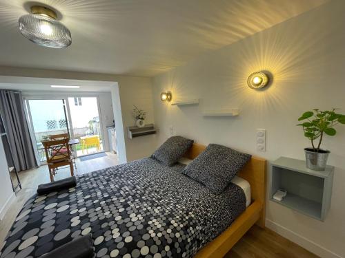 a bedroom with a bed with two pillows on it at Les studios du chemins vert in La Rochelle