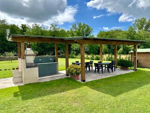 a pavilion with tables and chairs in a yard at Villa Amanda in Scorcetoli