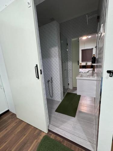 a bathroom with a shower and a sink at Aurora Country Home in Sandakan