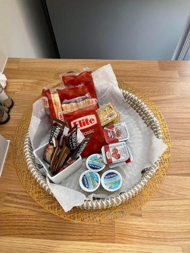 a basket of candy and snacks on a table at Dina's Apartment in Vonitsa