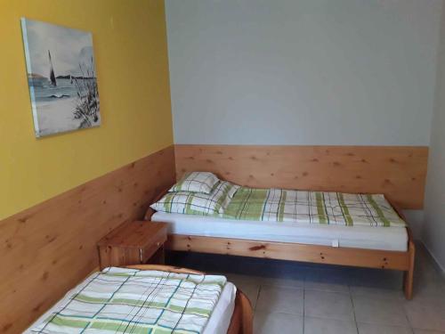 two twin beds in a room with yellow walls at Holiday home in Szantod - Balaton 20218 in Szántód