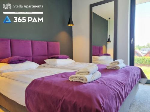 Katil atau katil-katil dalam bilik di Apartament nr 32 w Mielenku - BASEN ZEWNĘTRZNY, BASEN KRYTY, PLAC ZABAW- 365PAM
