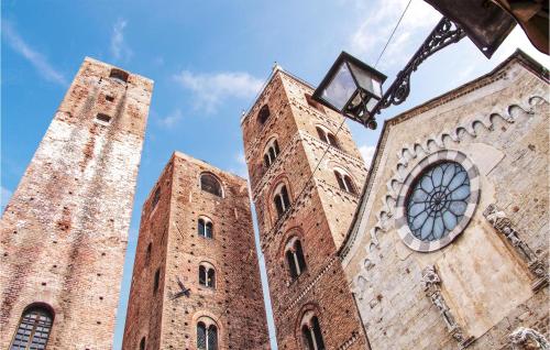 two towers of a building with a clock on it at 1 Bedroom Stunning Apartment In Genova in Genova