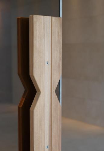 a close up of a wooden door with a mirror at Clarion Hotel Karlatornet in Gothenburg