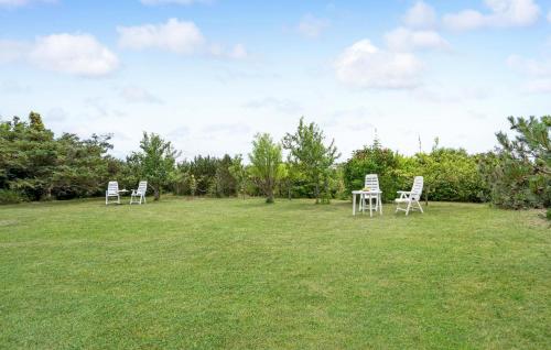 a group of chairs sitting in a grass field at Lovely Home In Slagelse With Kitchen in Slagelse