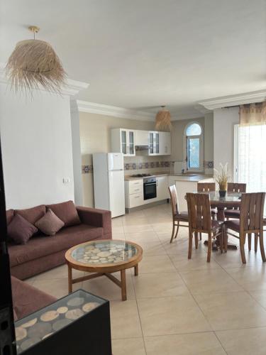 a living room with a couch and a table at Hekma By El kateb in Fafou