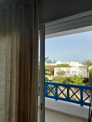 a sliding glass door with a view of the ocean at Hekma By El kateb in Fafou