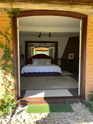 a bedroom with a bed in the middle of it at Chalés do Cachoeirão in Visconde De Maua