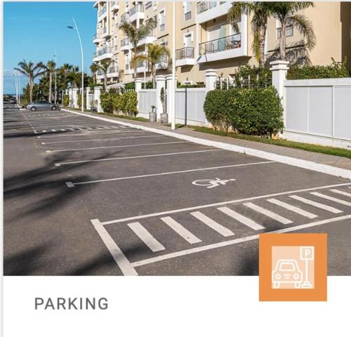 an empty street with a parking sign on the road at Shems Bouznika kettani in Bouznika