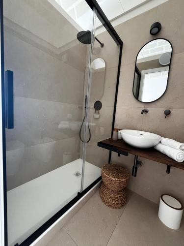 a bathroom with a shower and a sink at Acqua Salmastra Apartment in Favignana